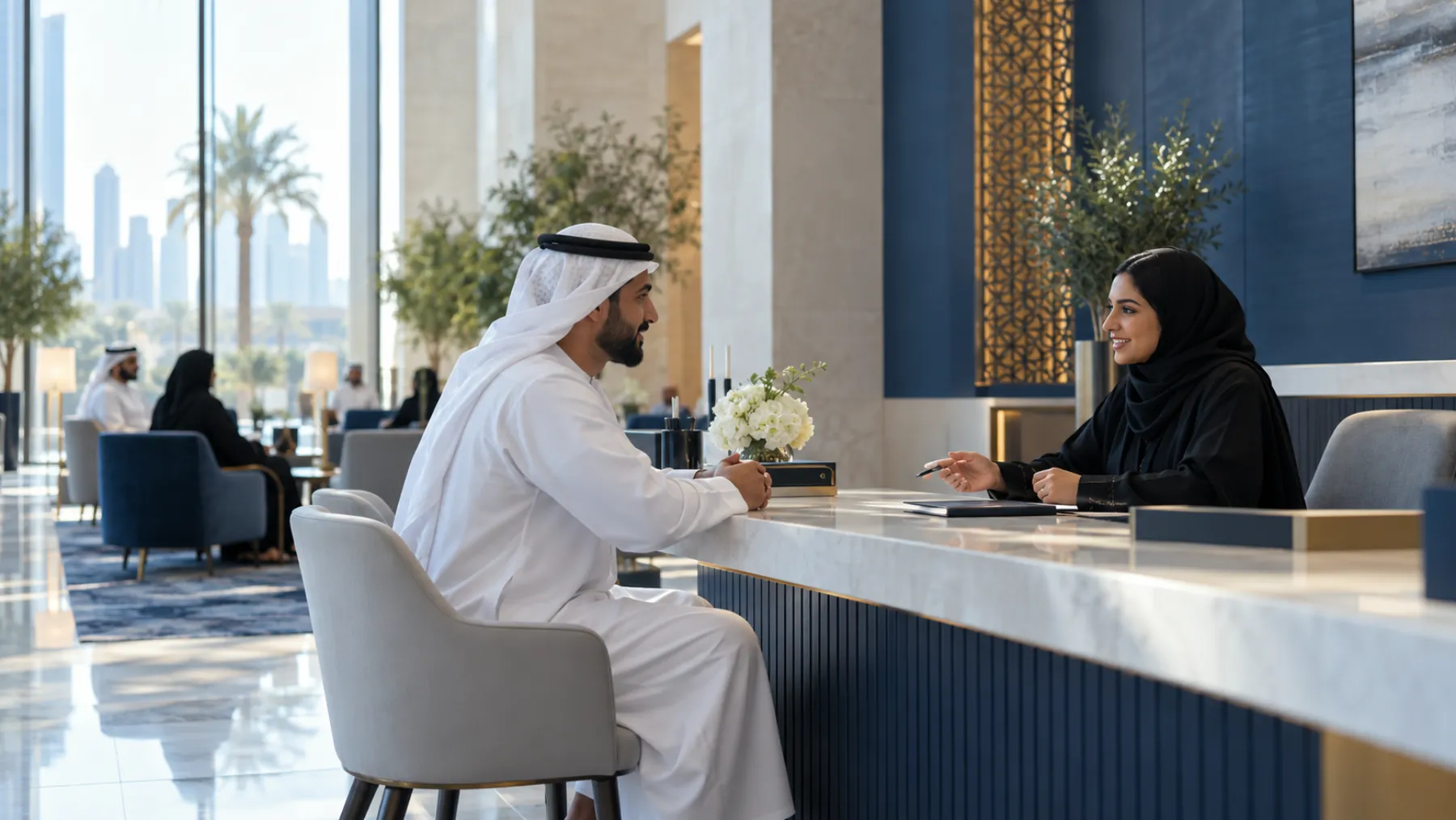 A calm service centre with high ceilings; a man in a kandura talks with a staff member in an abaya at a service desk.